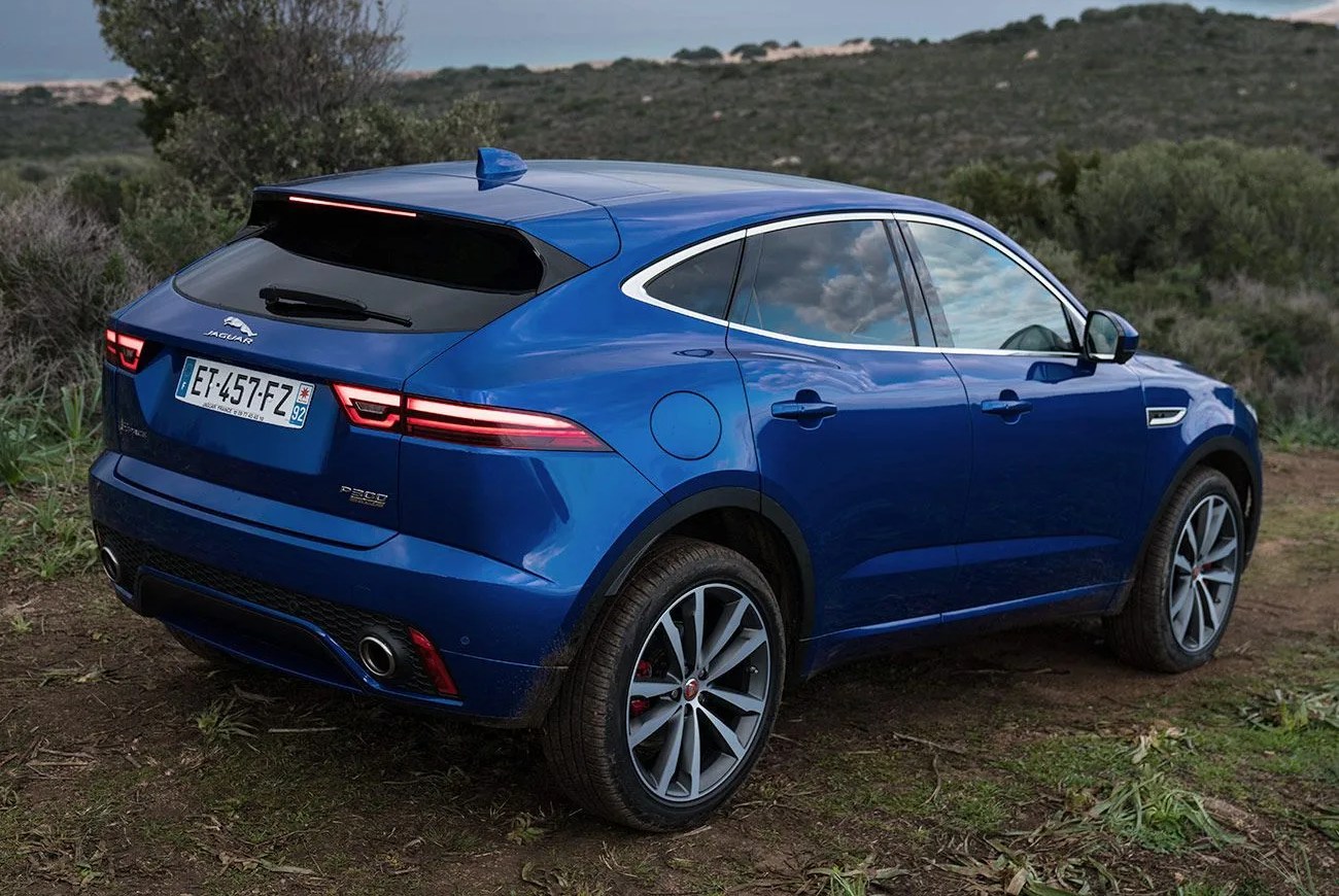 jaguar e pace parked on a hill overlooking the ocean