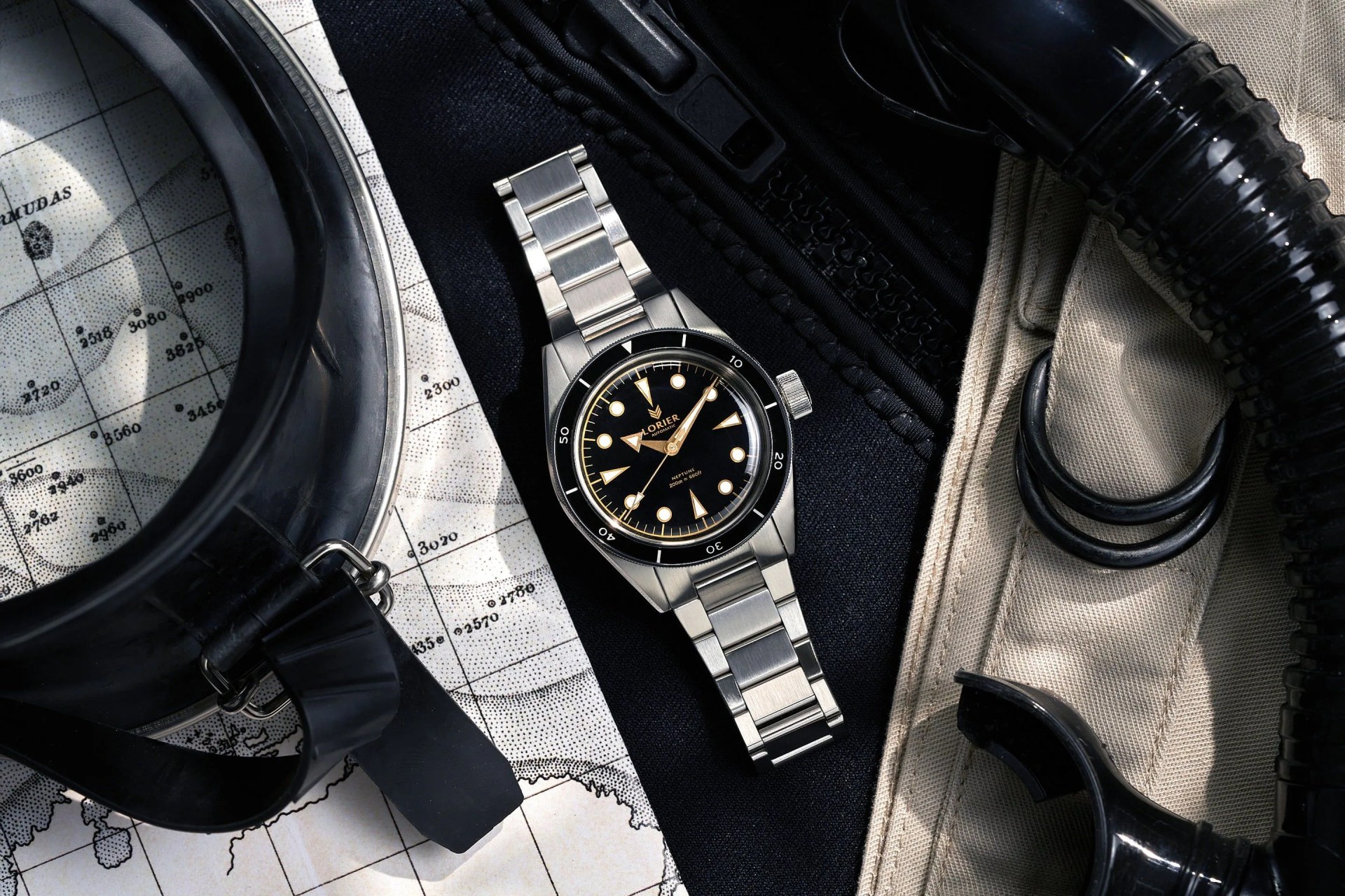 a dive watch on a table with diving gear