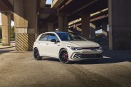 white volkswagen golf gti parked under a highway