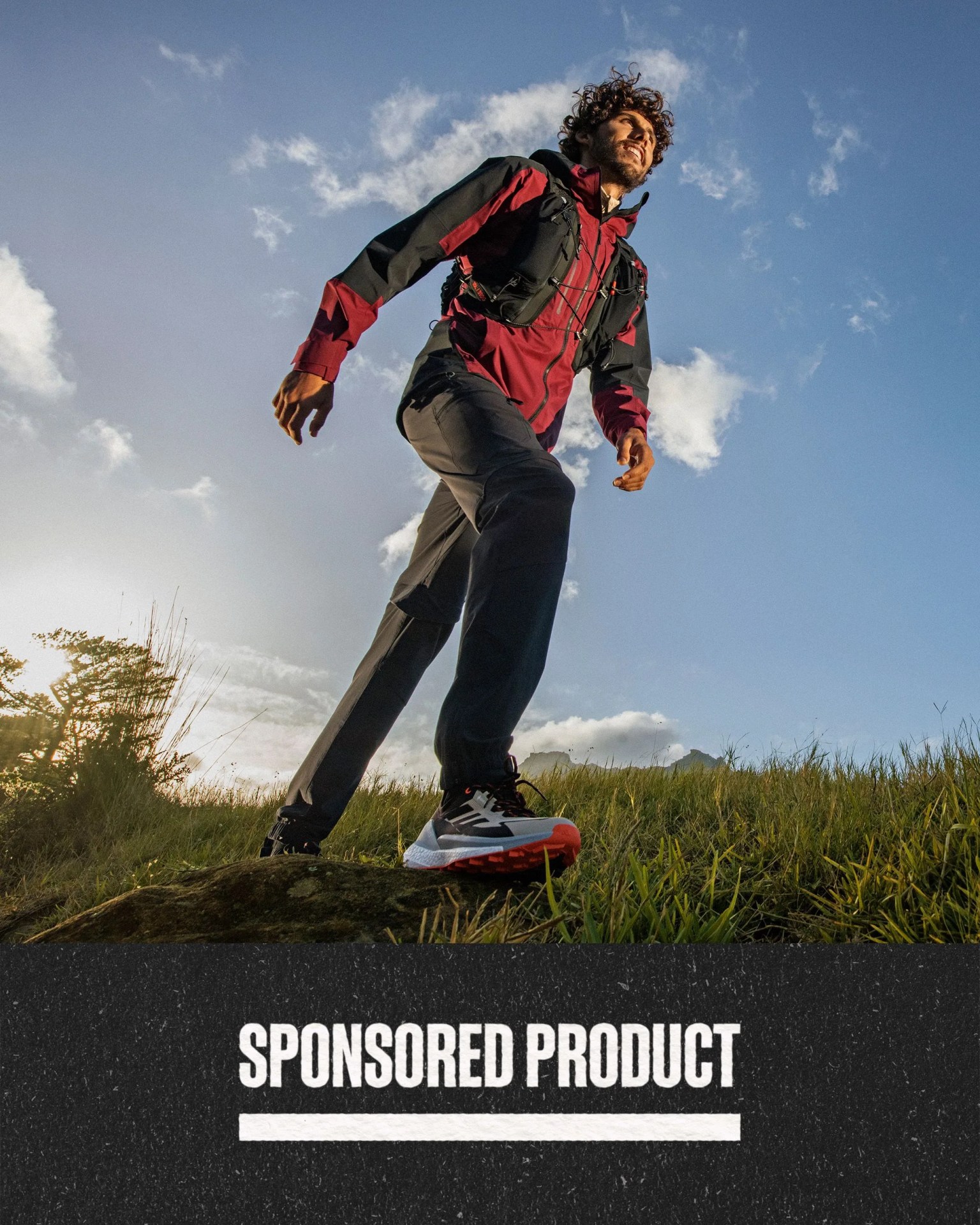 sponsored product man wearing adidas free hiker sneakers while hiking over grassy land