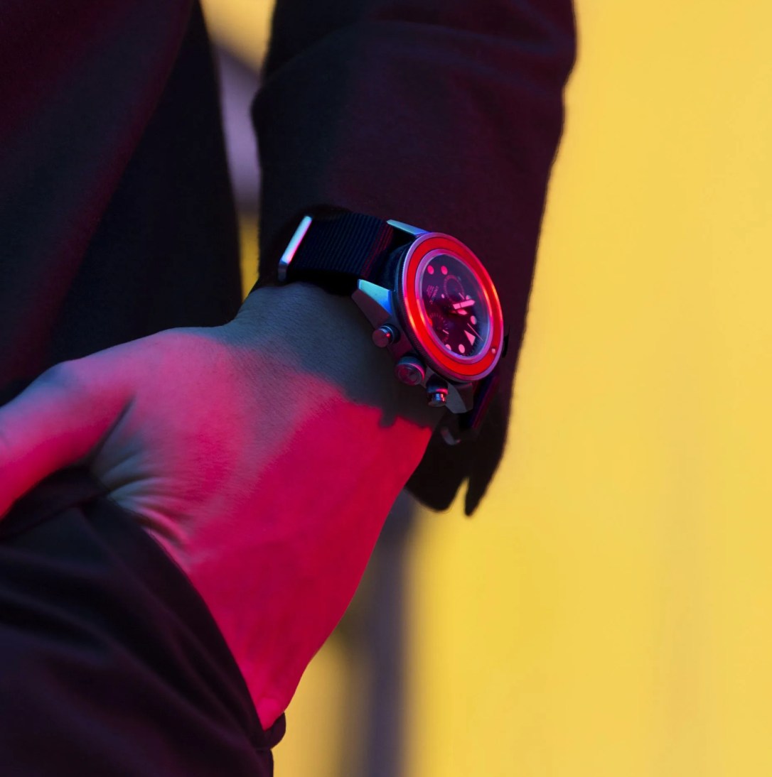 a man wearing a watch with his hand in his pocket