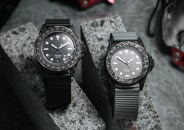 two watches on concrete background