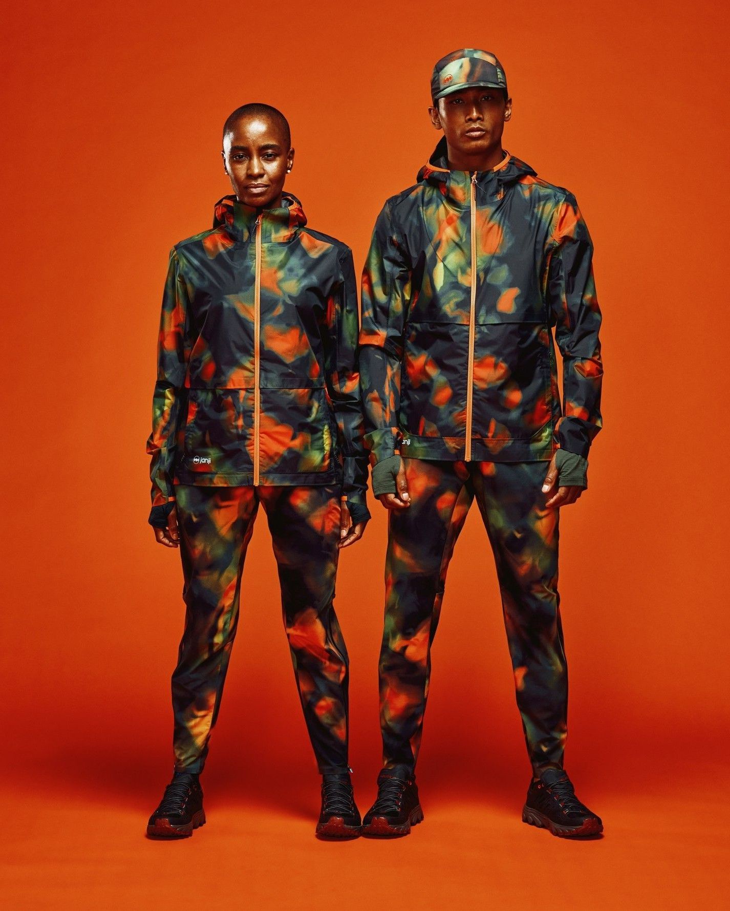 man and woman wearing janji autumn flux running gear collection