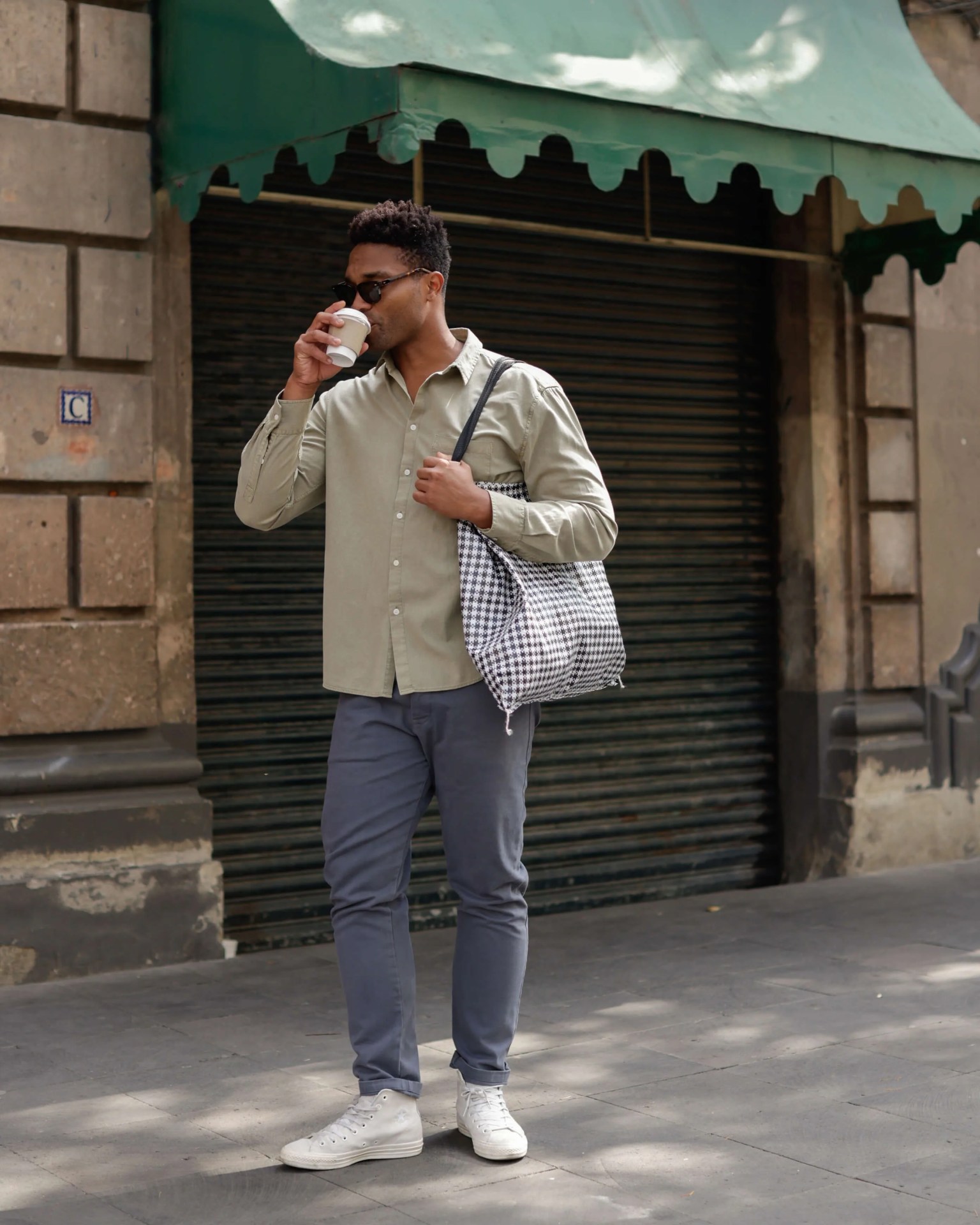 man drinking coffee wearing alex crane porto shirt in wave