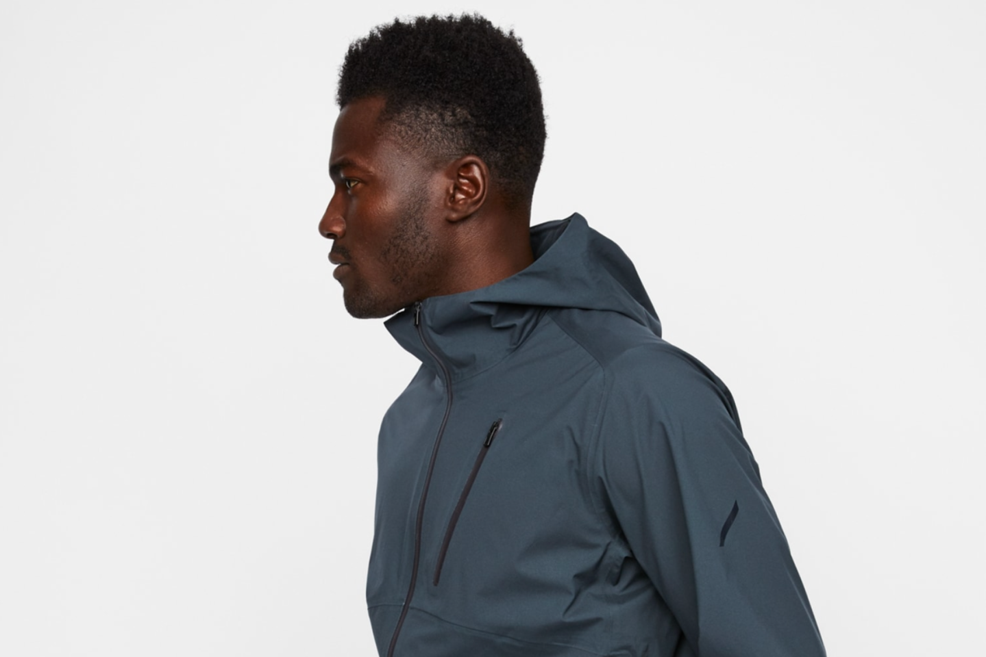 a model wearing a gray rain jacket