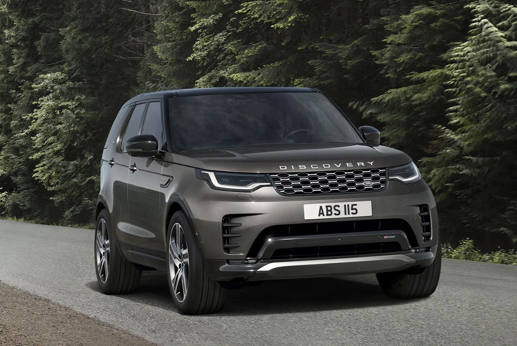 discovery driving on road through the trees