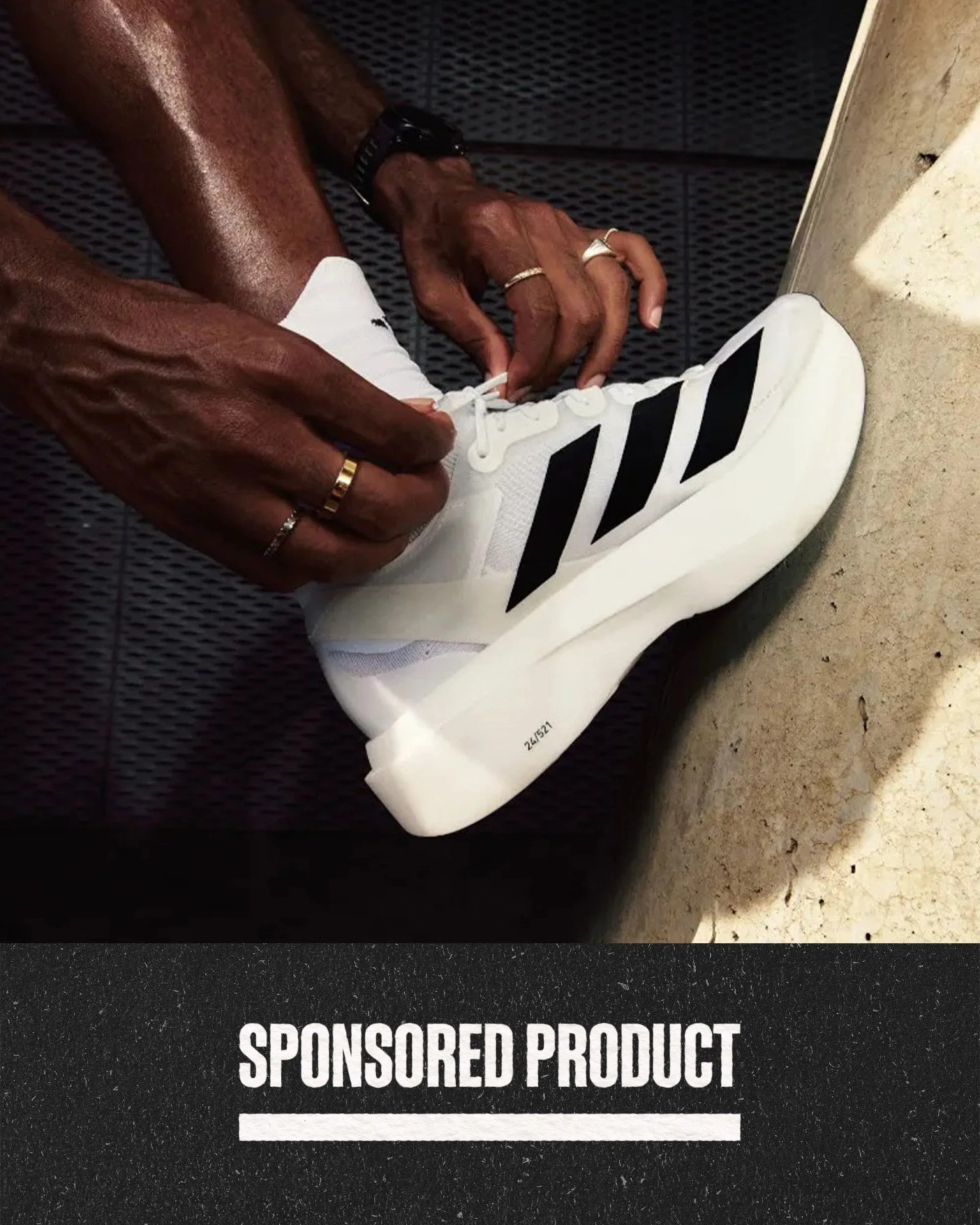 sponsored product man tying his shoelace on his adidas new adizero sneaker