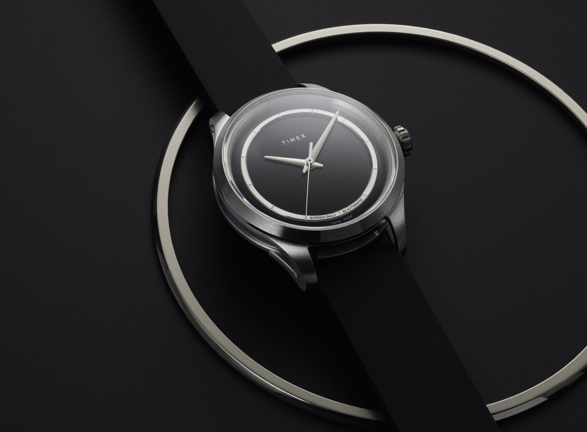 watch on table with a large steel ring
