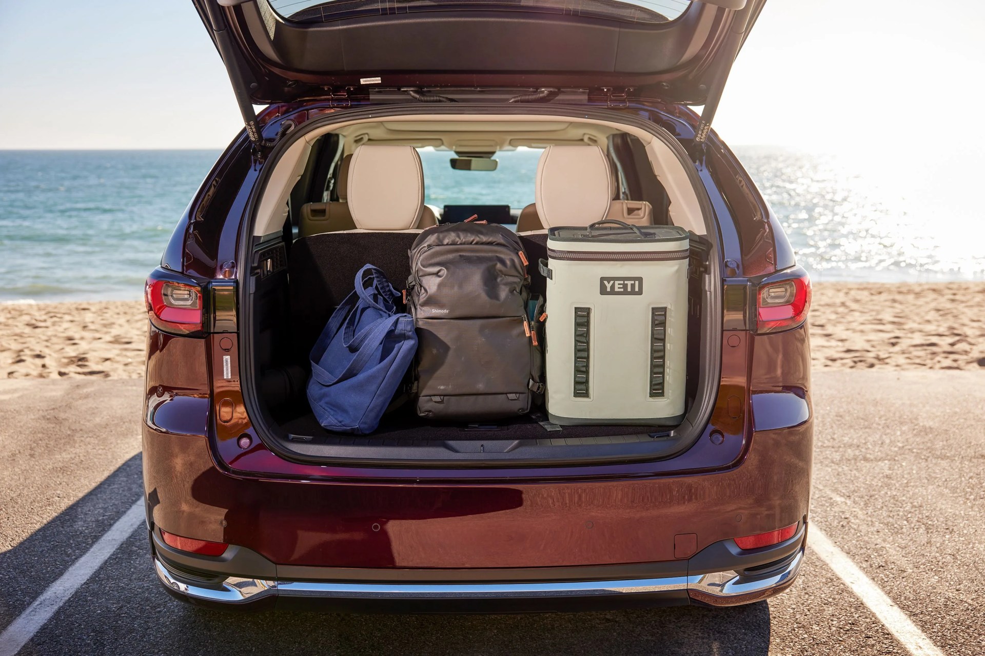 the back of a mazda open to show bags in the trunk