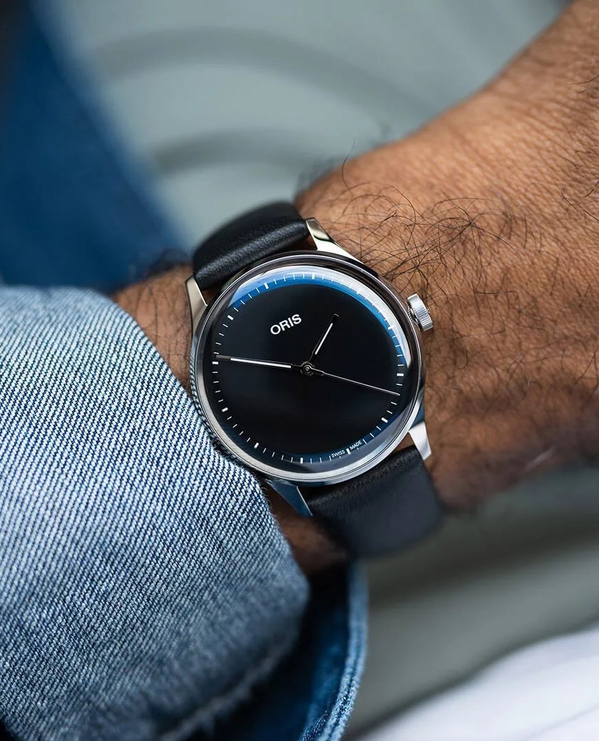 a person wearing oris artelier s watch