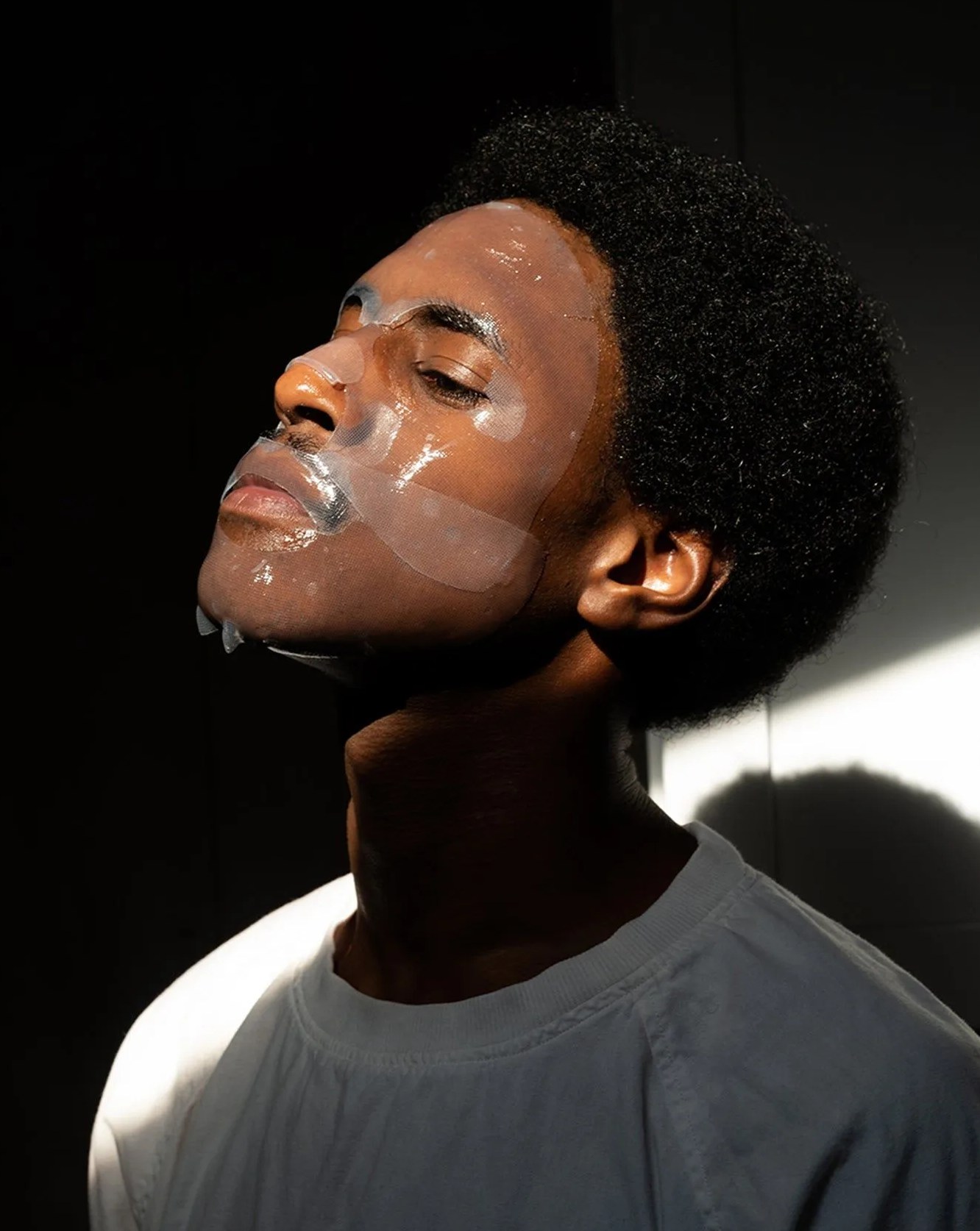 a man wearing jaxon lane bro mask on face with eyes closed