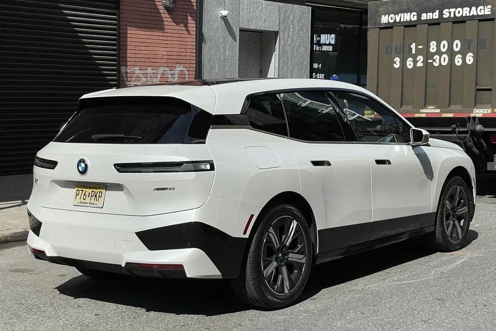 a white car parked in front of a building