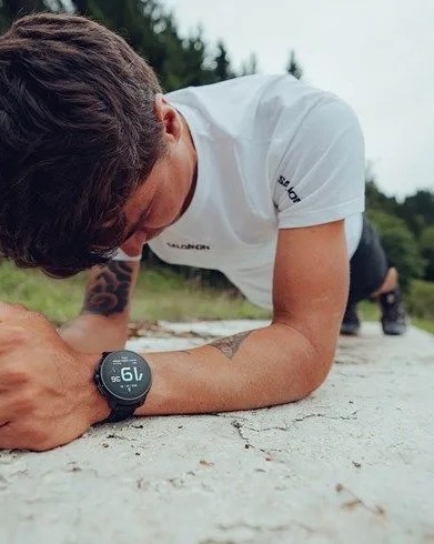 man planking outside wearing suunto race al black watch