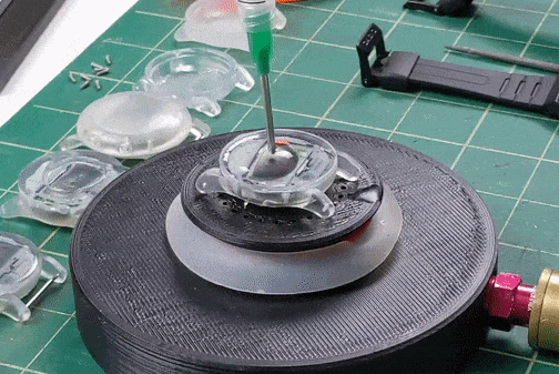 a machine putting resin on a watch face