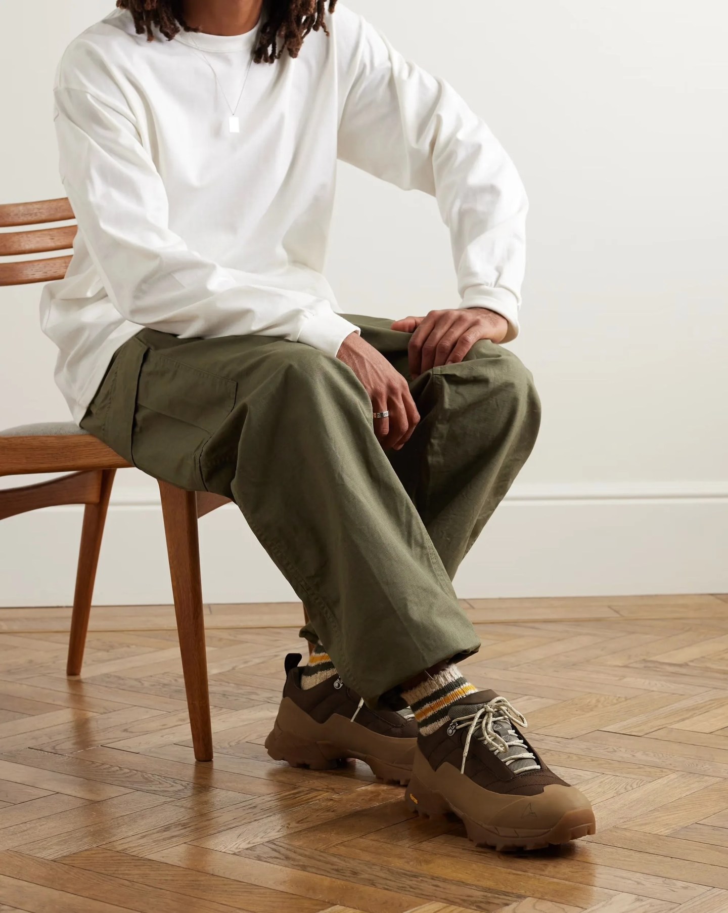 a person wearing roa katharina leather trimmed rubber and mesh hiking sneakers