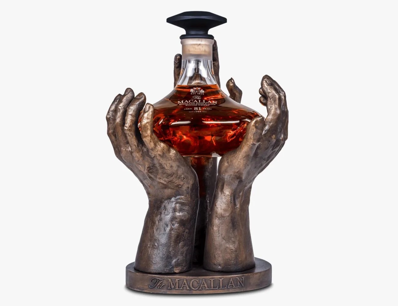 a bottle of alcohol being held by sculpted hands