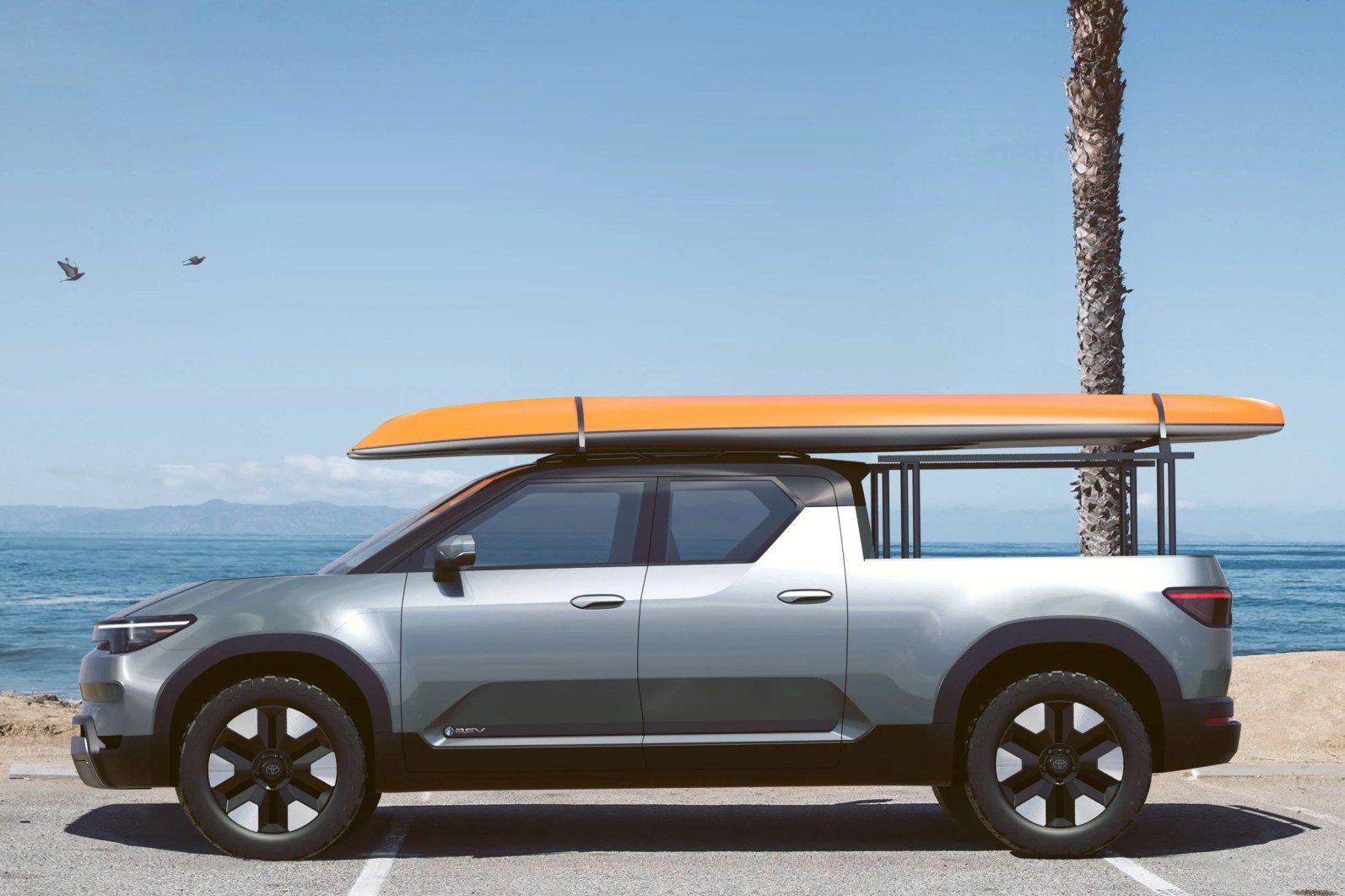 toyota electric pickup with surfboard on the roof