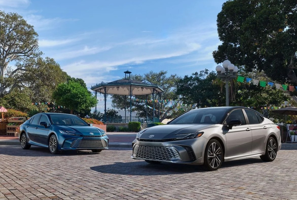 two cars parked on a brick road