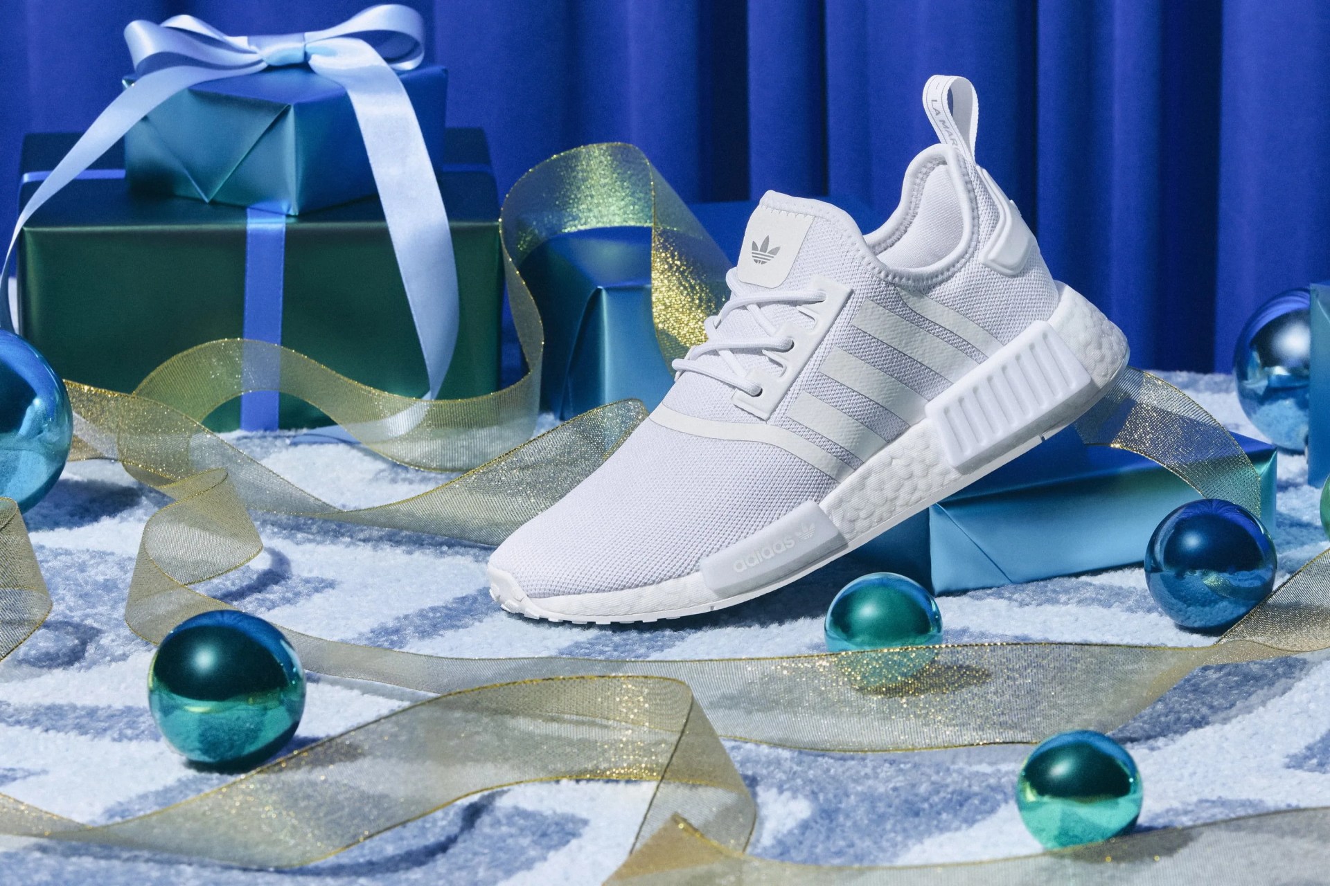 a pair of white adidas shoes on a holiday table