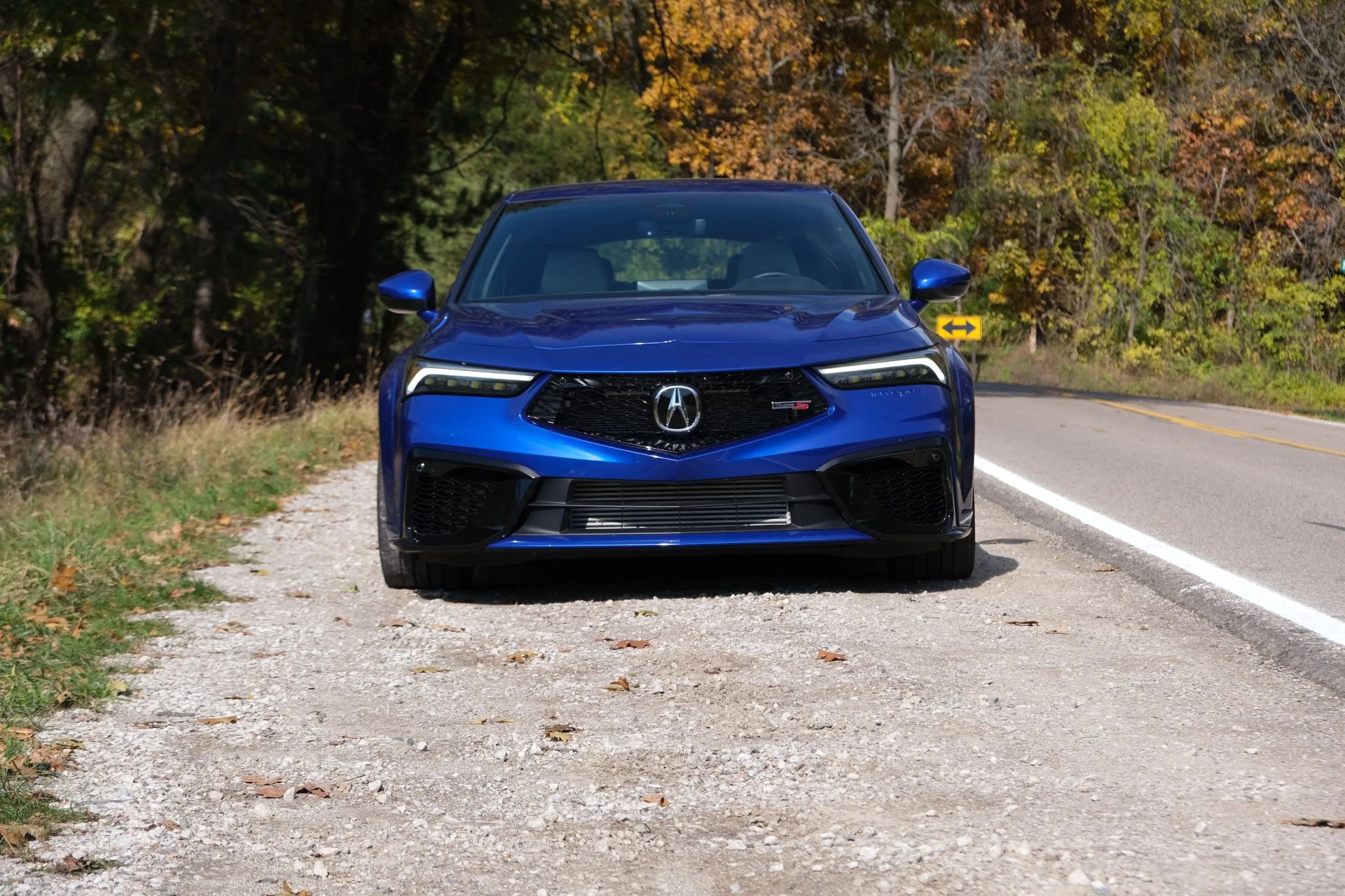 a blue car on a road