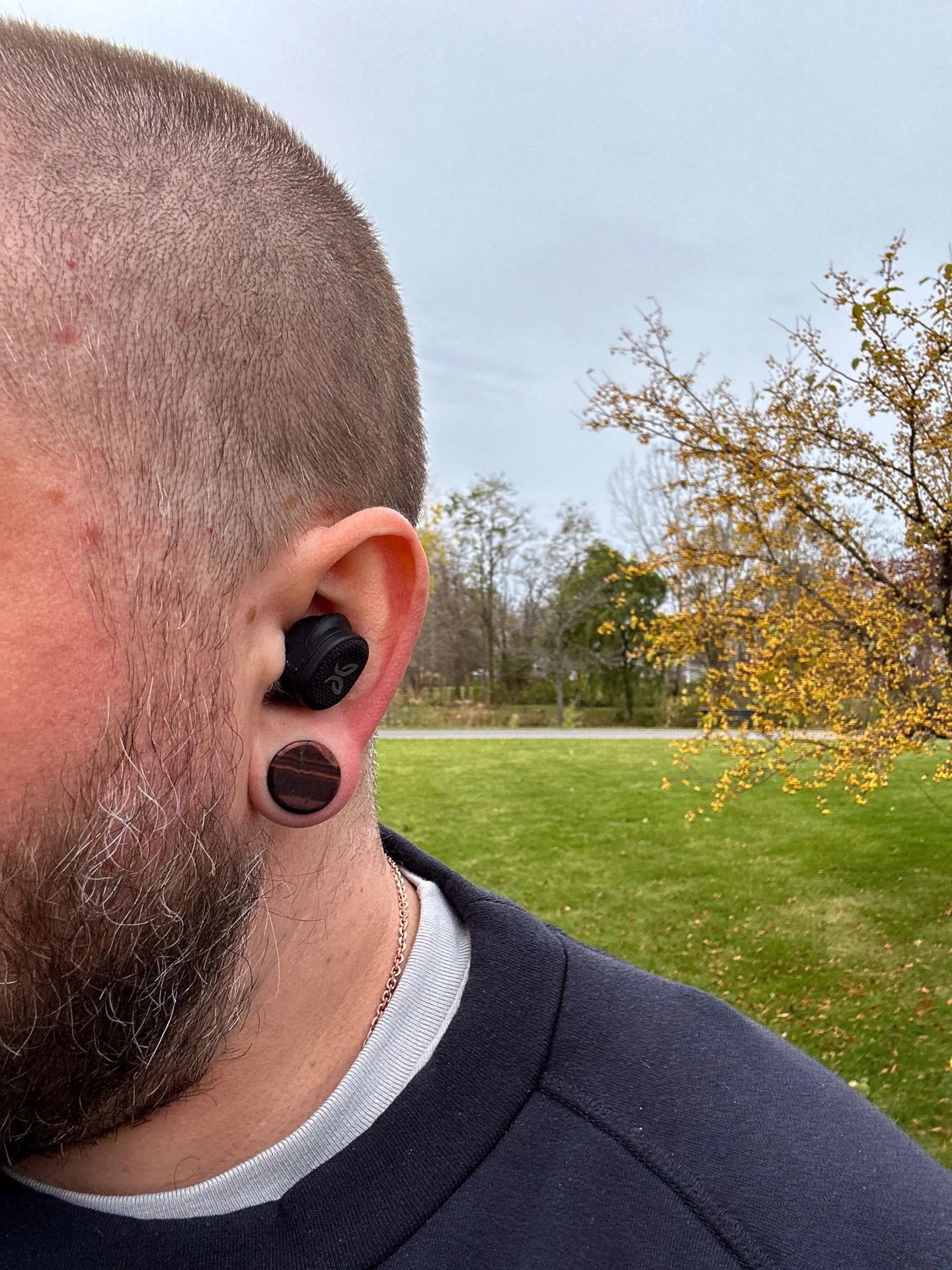 a man outside wearing ear buds