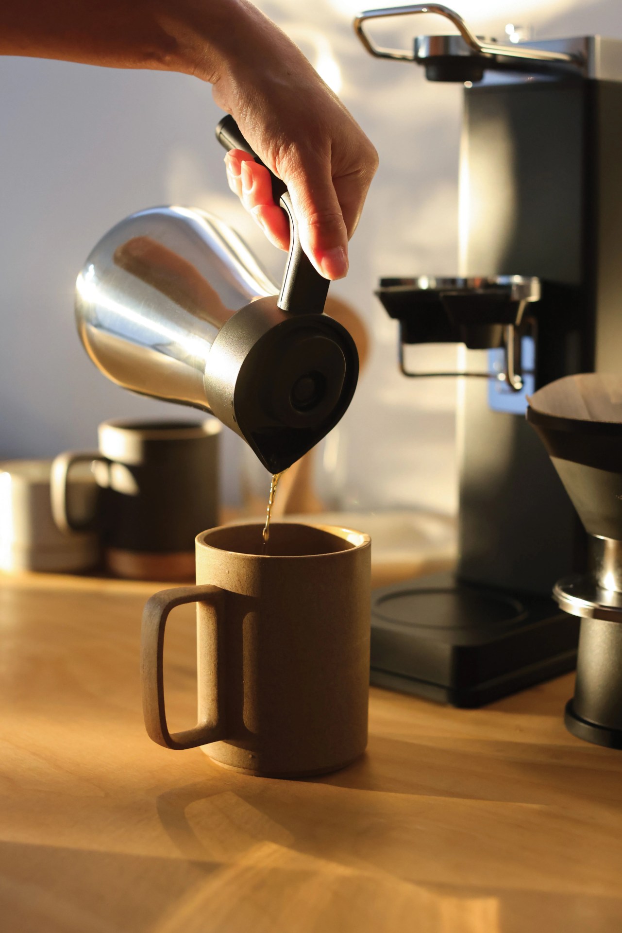 someone pouring coffee into a mug