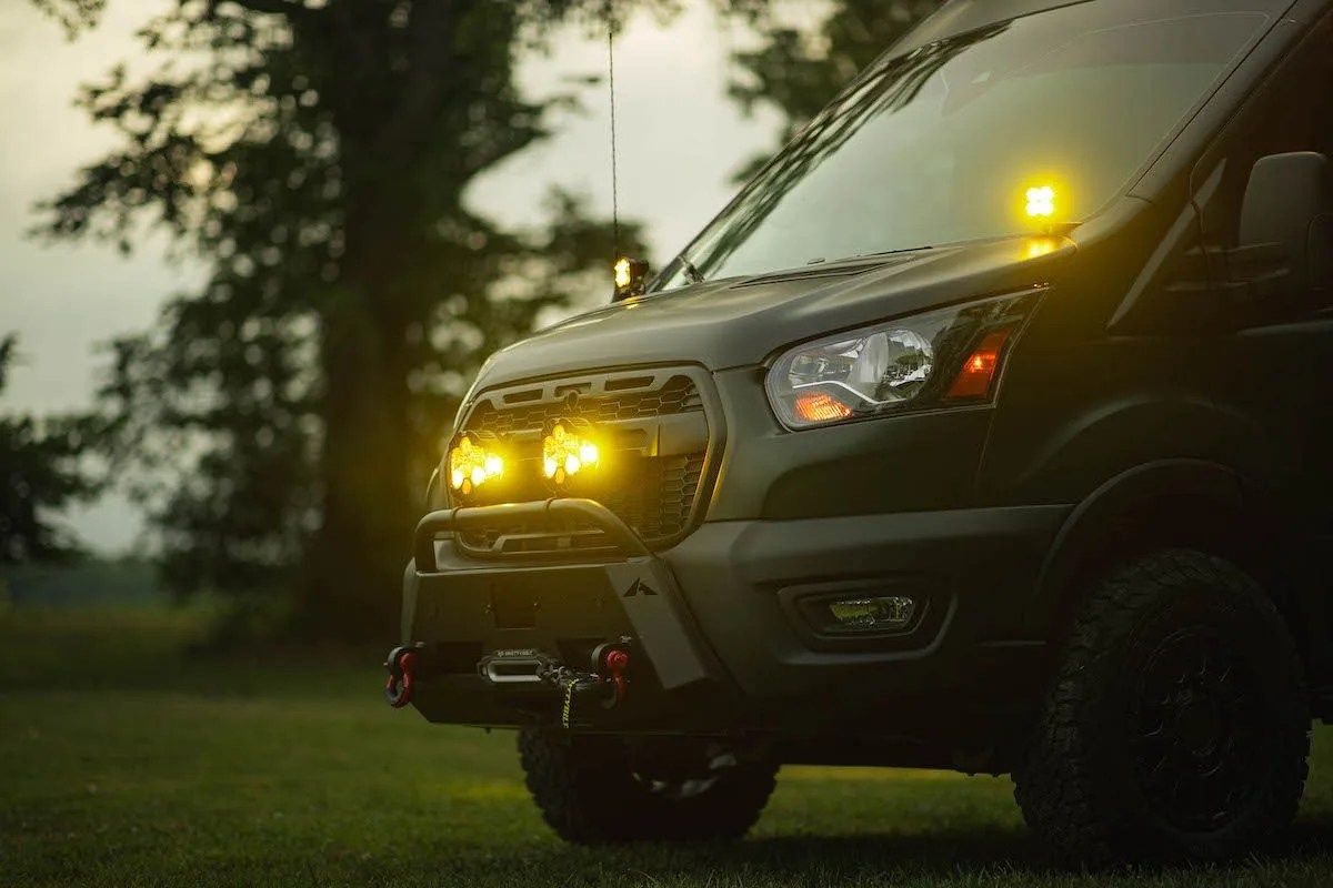 a camper van with its headlights on