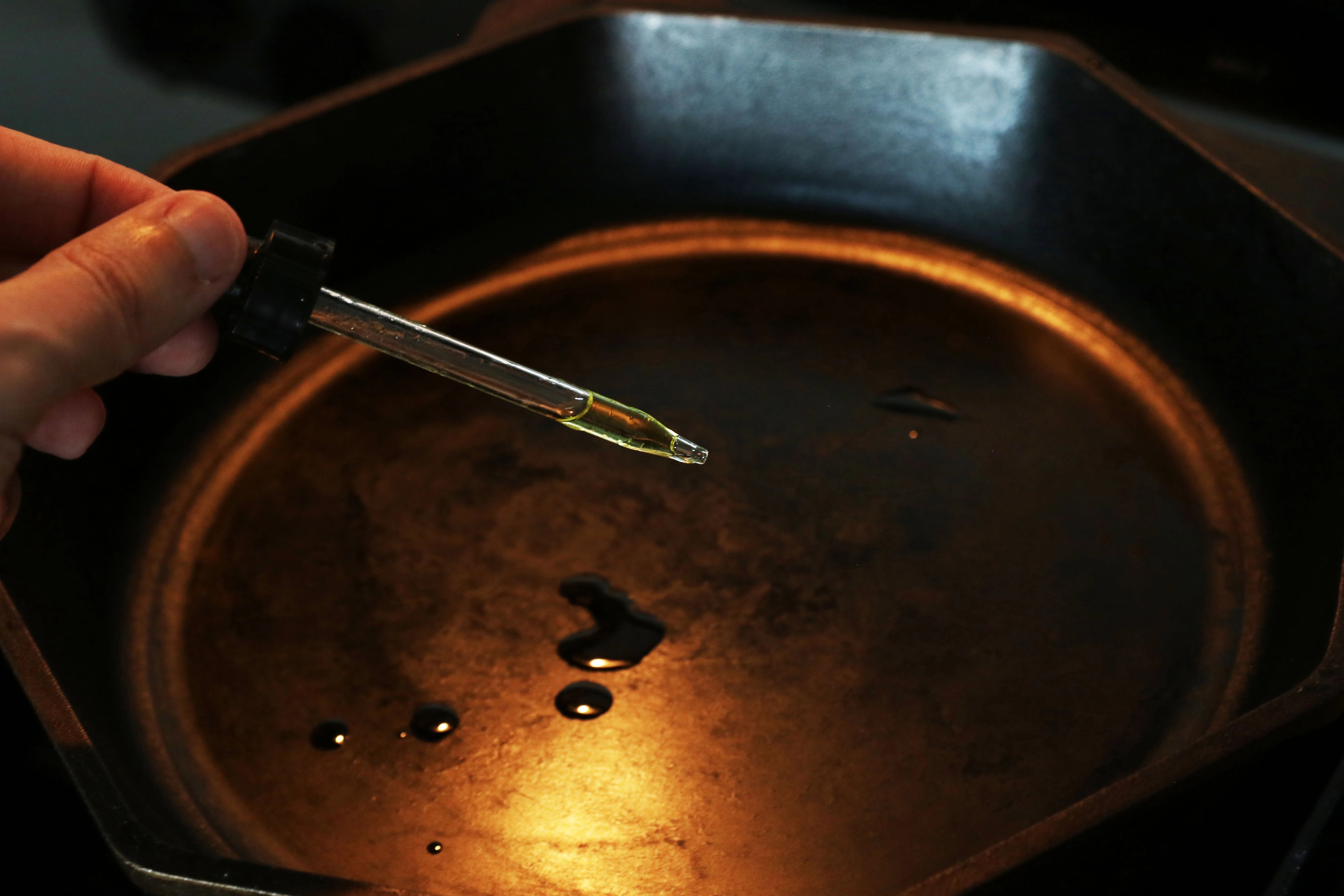 dripping oil onto a cast iron skillet