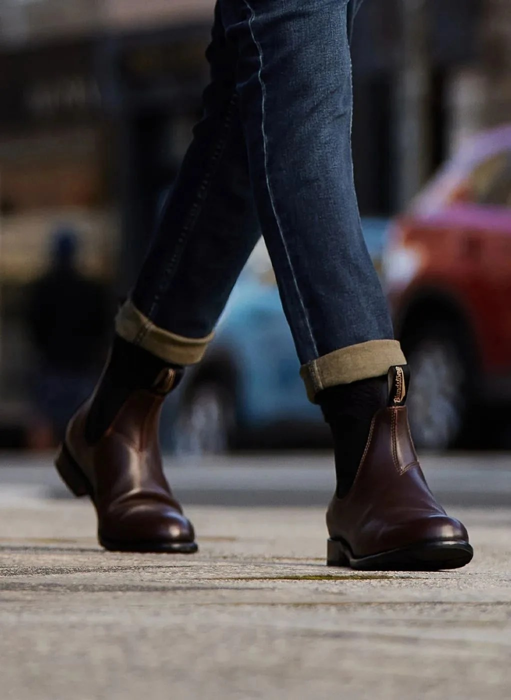 a person walking wearing blundstone chelsea boots