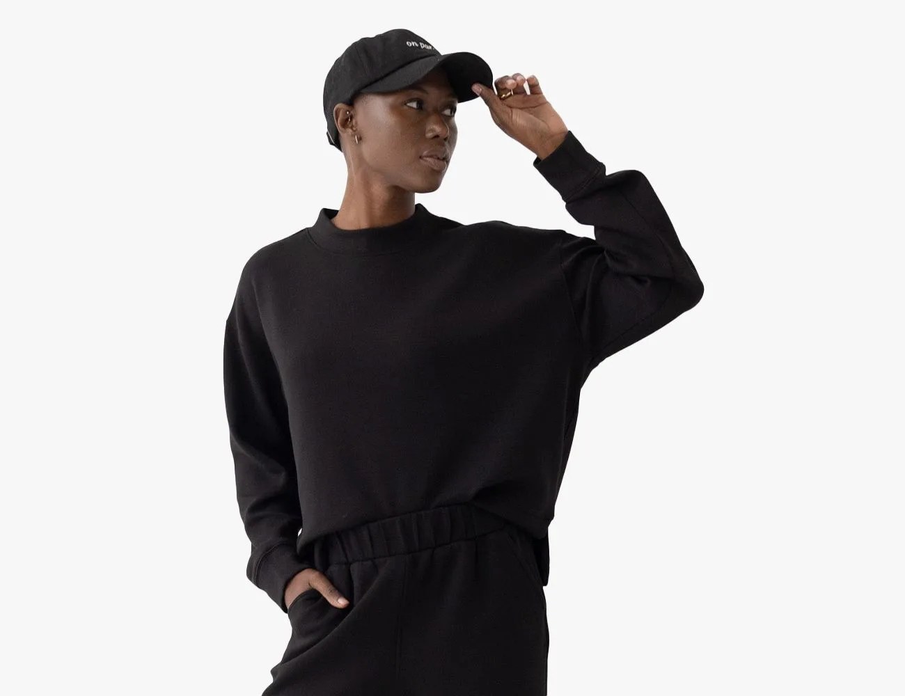 a person wearing a black hat sweatshirt