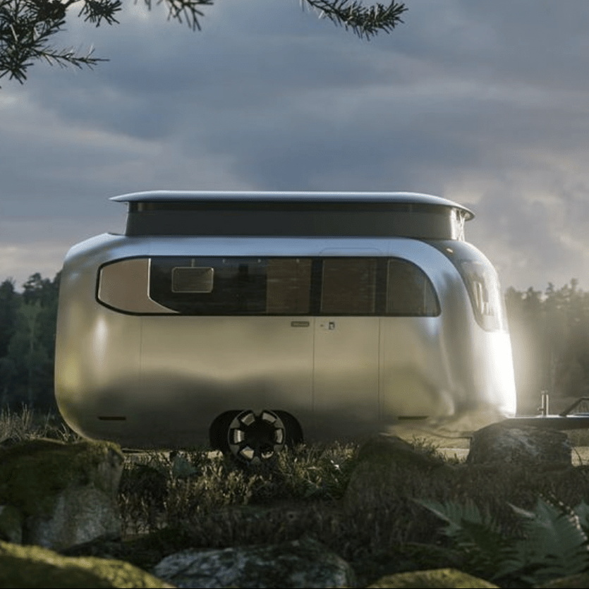 a car and a van parked on a rock in a foggy forest