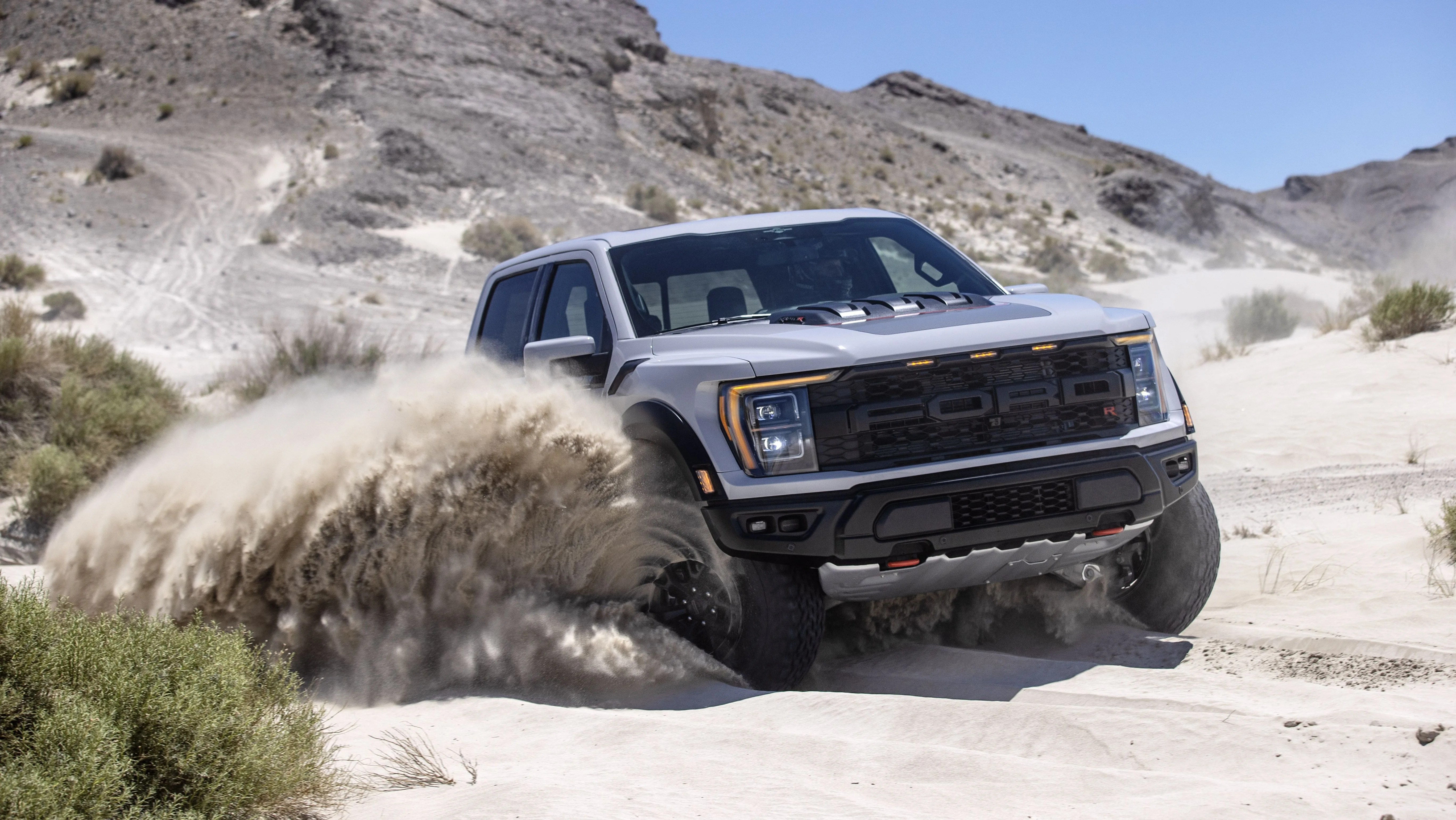 f 150 raptor r pickup driving through sand