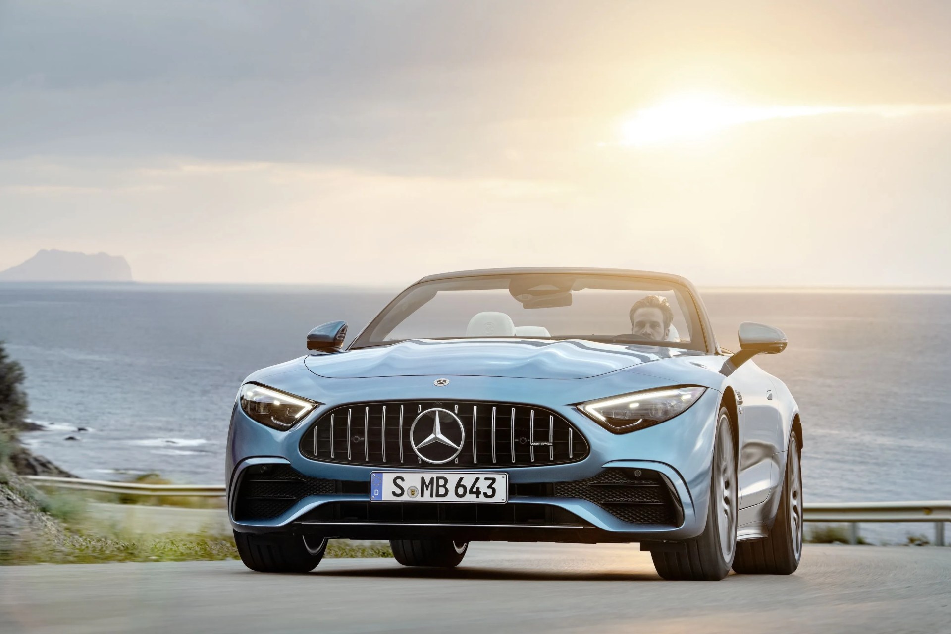 mercedes amg sl 43 roadster driving down sunny coastal highway