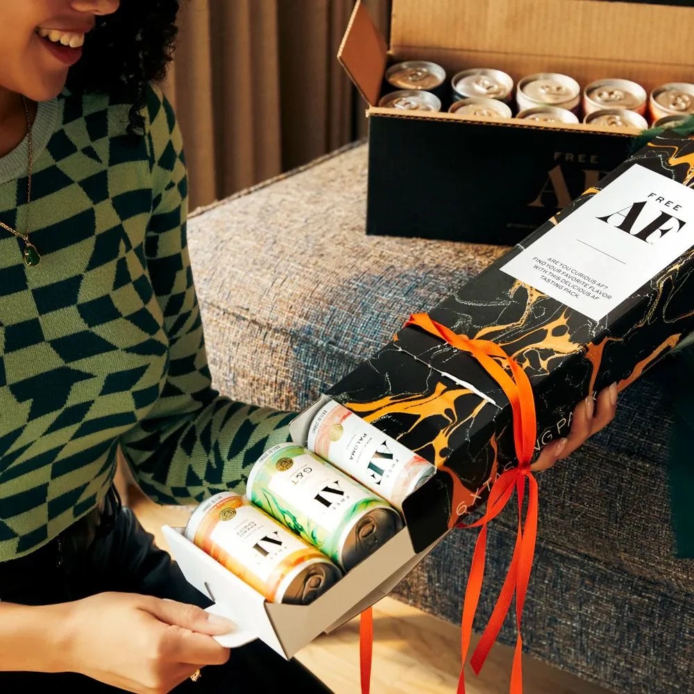 a person holding a box of af drinks