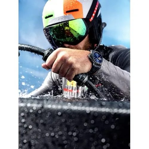 a man in a helmet and goggles in the water wearing panerai luminor marina carbotech luna rossa