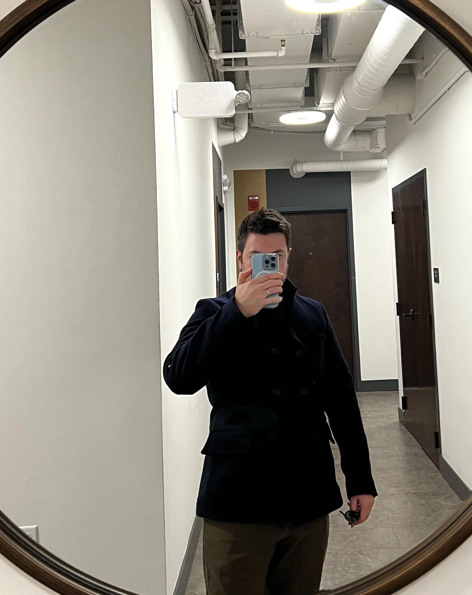 a person taking a selfie in a hallway