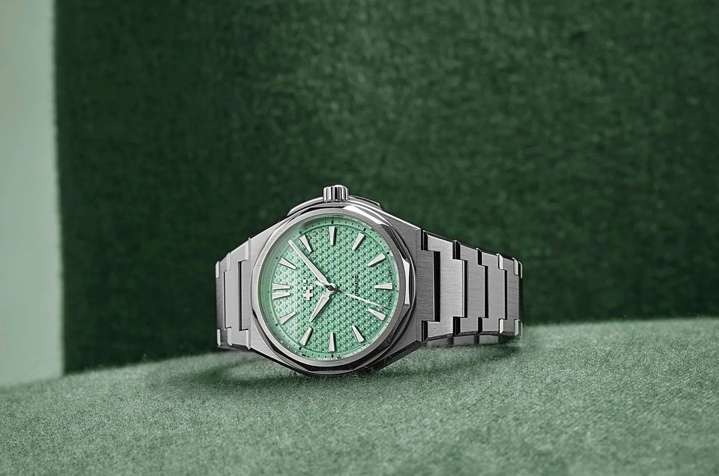 a watch on a green surface