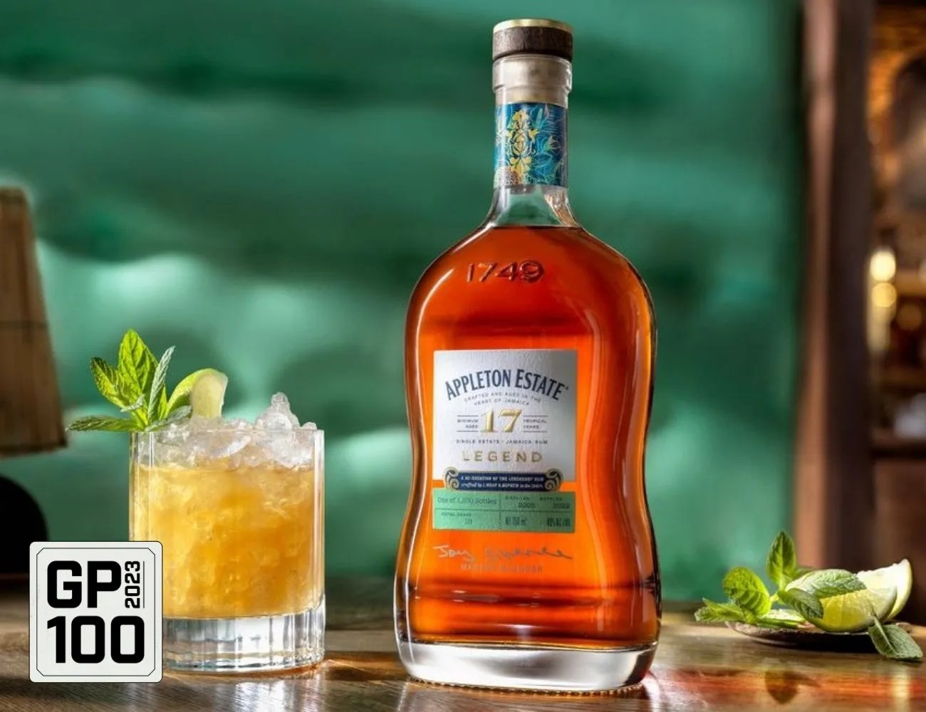 a bottle of alcohol next to a cocktail