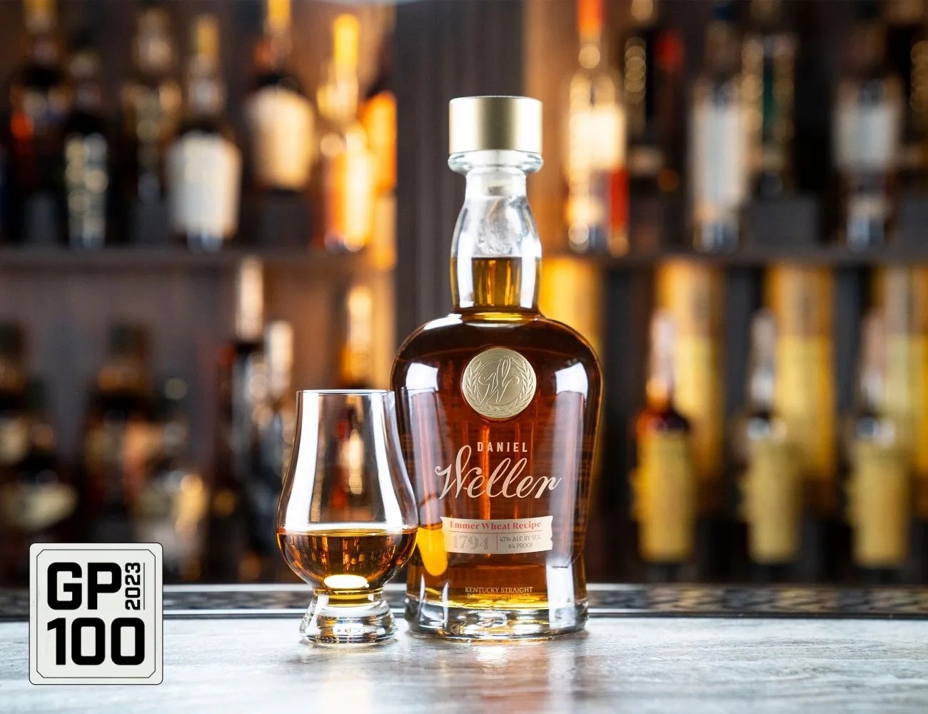 a bottle of alcohol and a glass of whiskey on a table