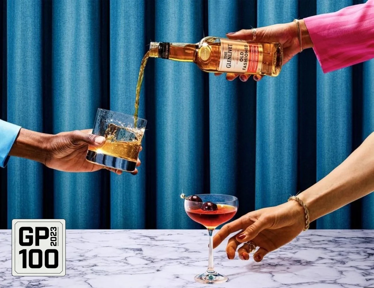 a few hands holding glasses of alcohol