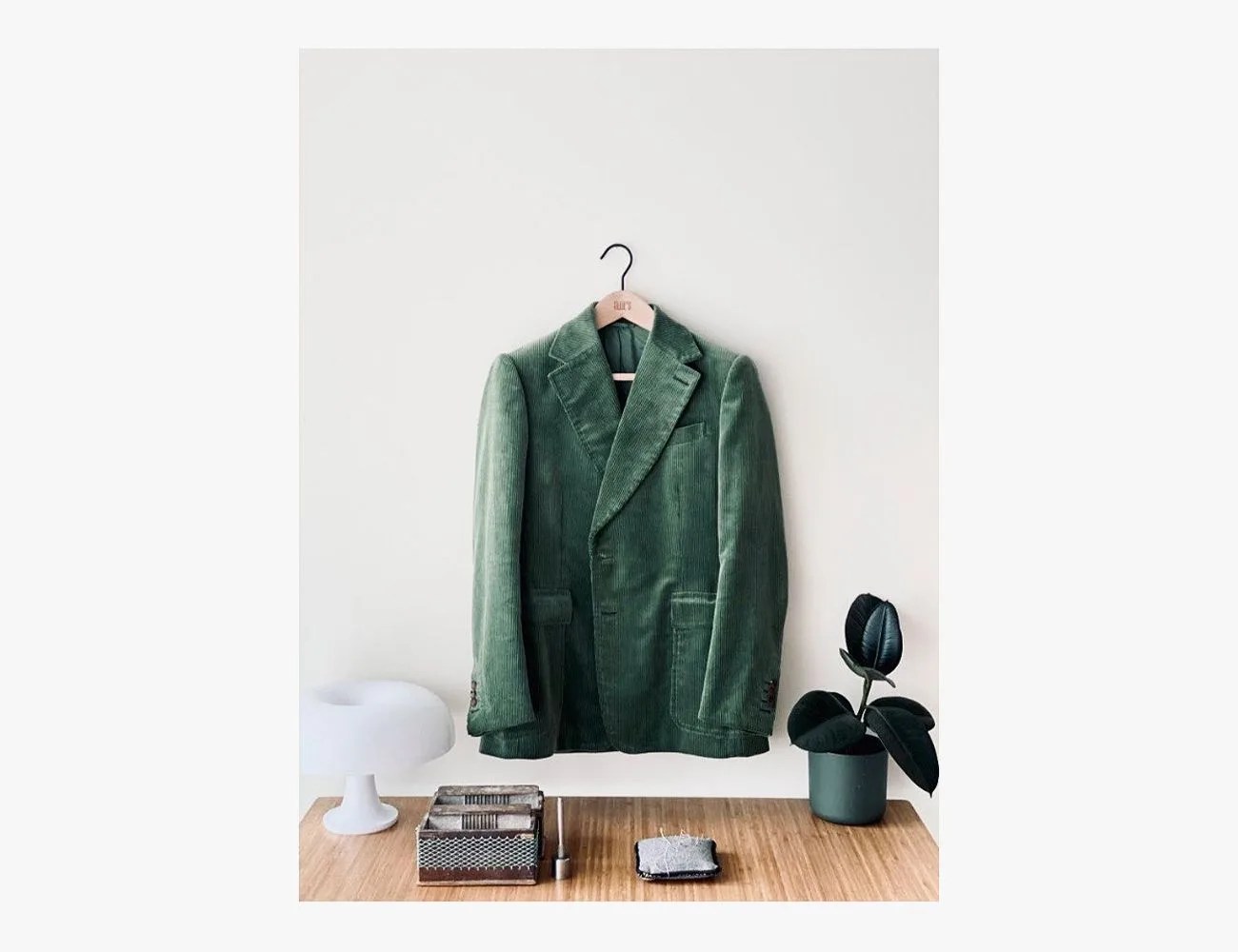 a green coat on a wall