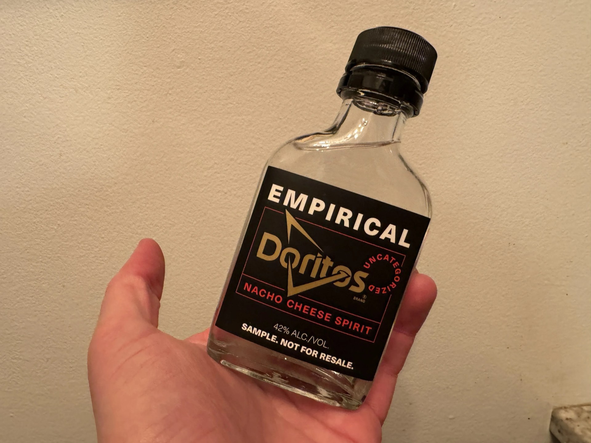 a hand holding a bottle of alcohol