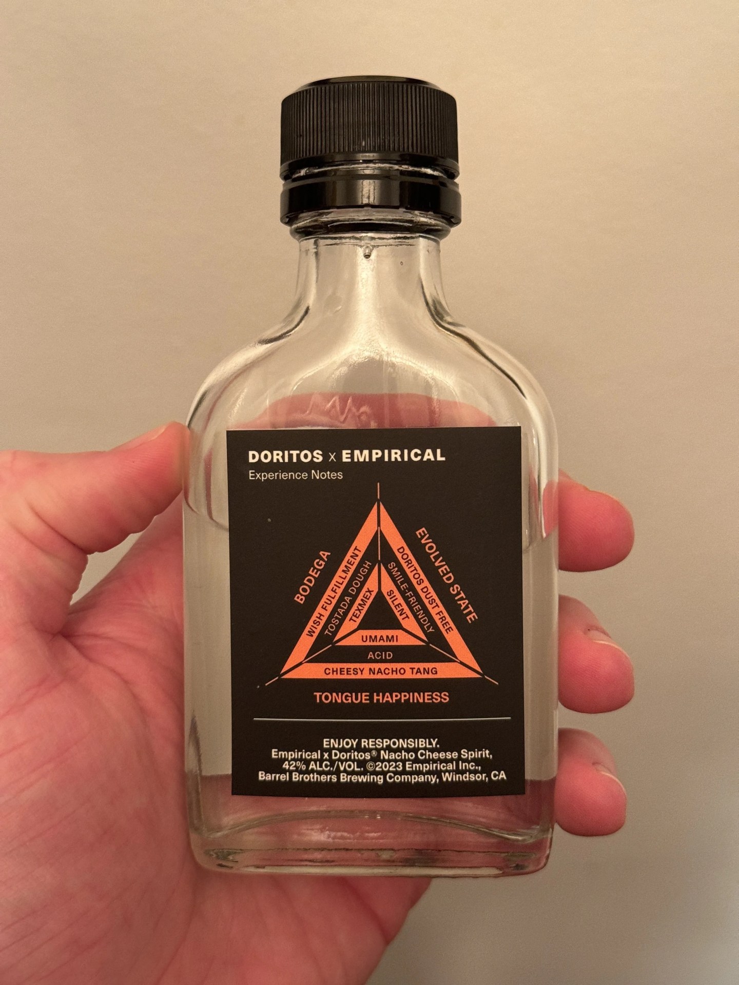 a hand holding a bottle of alcohol