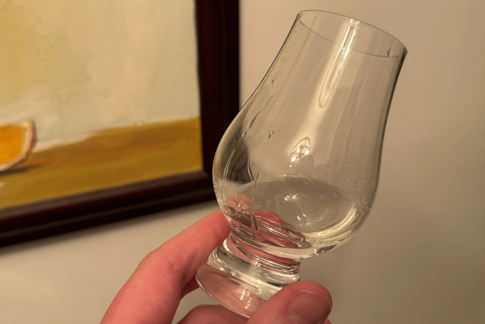 a hand holding a glass of wine