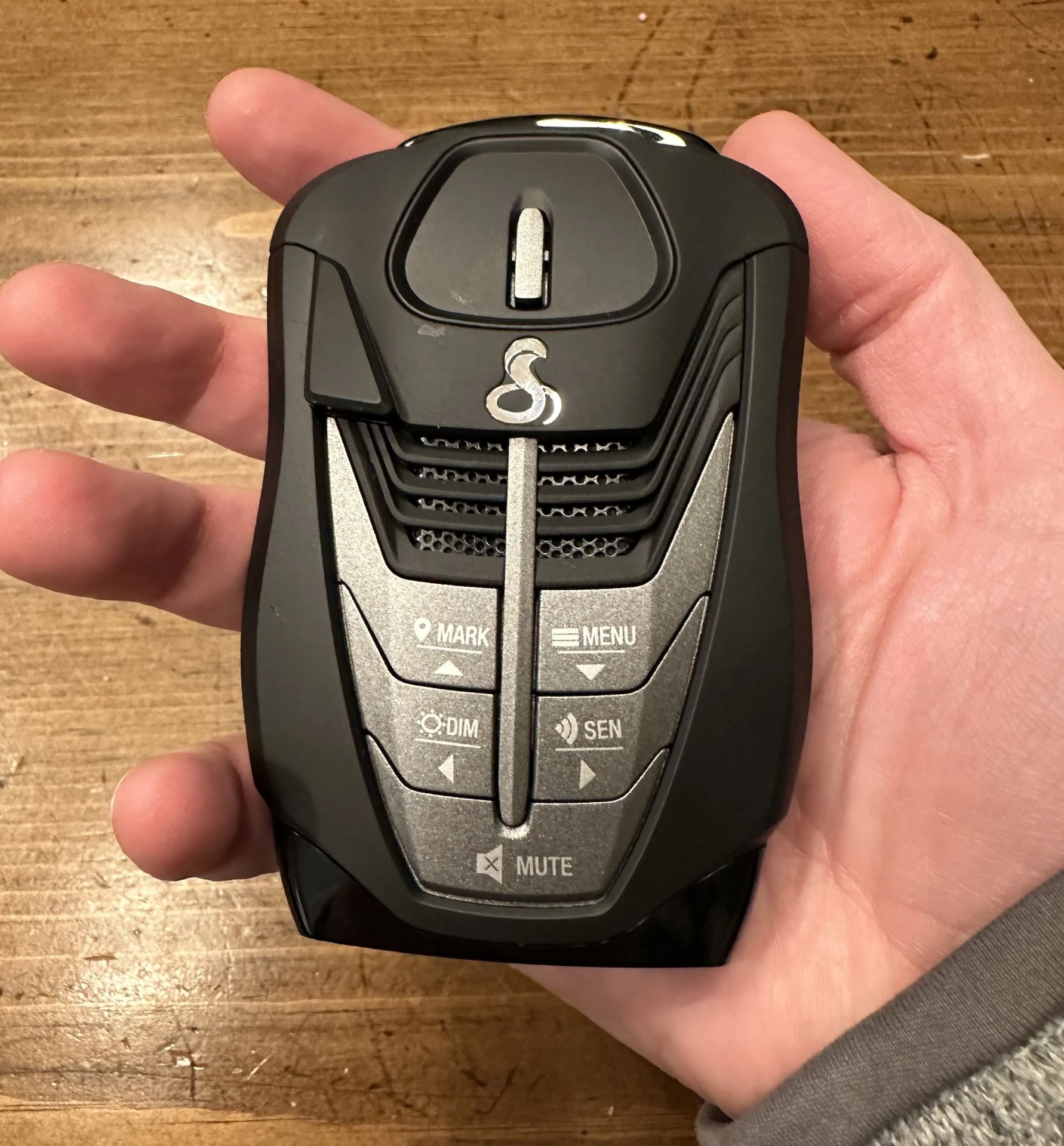 a hand holding a radar detector