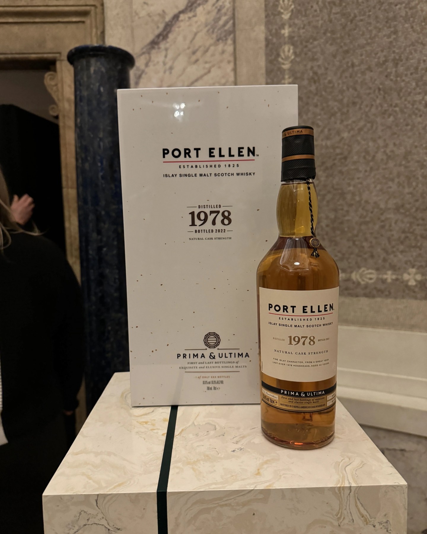 a bottle of whisky next to its box