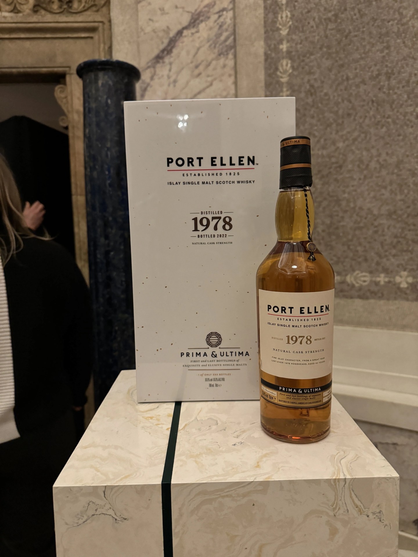 a bottle of whisky next to its box