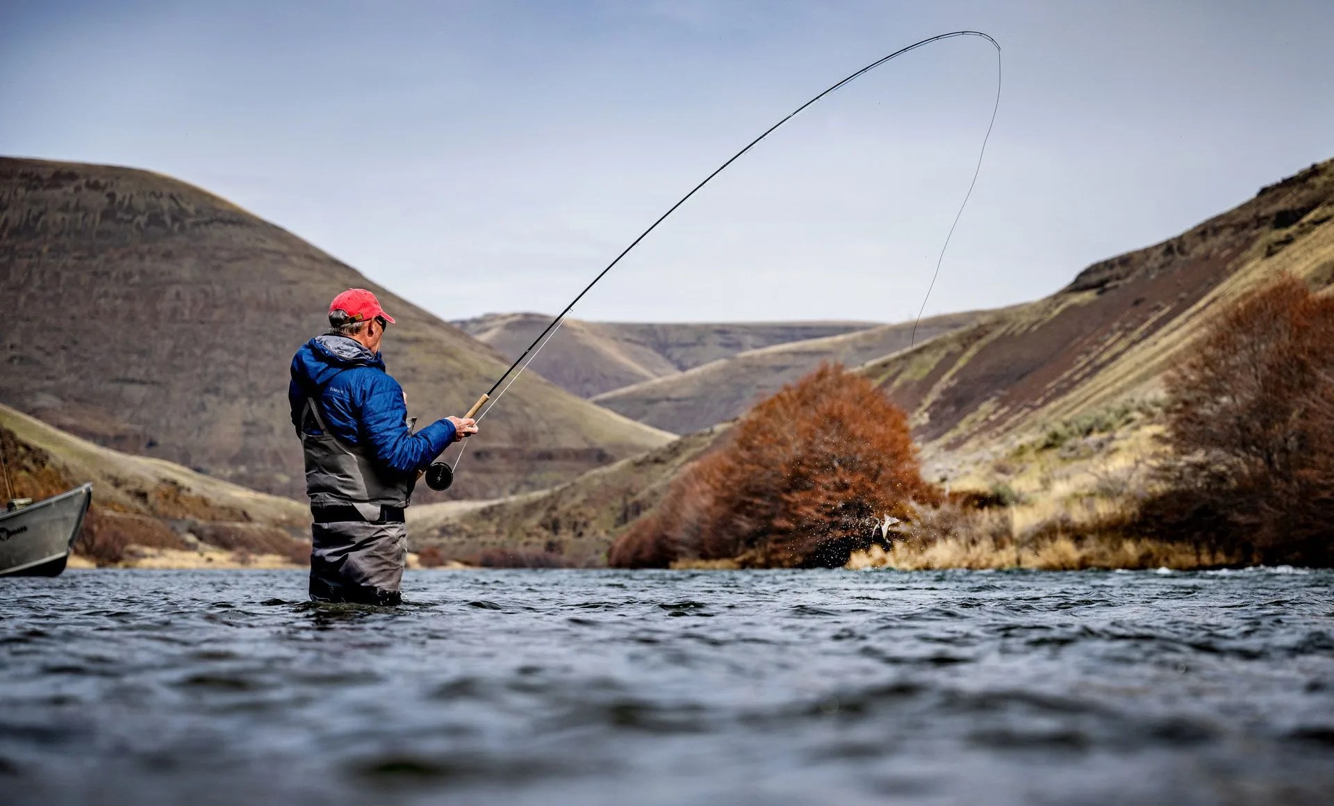 a man fishing in a river with the microspey air 2 rod
