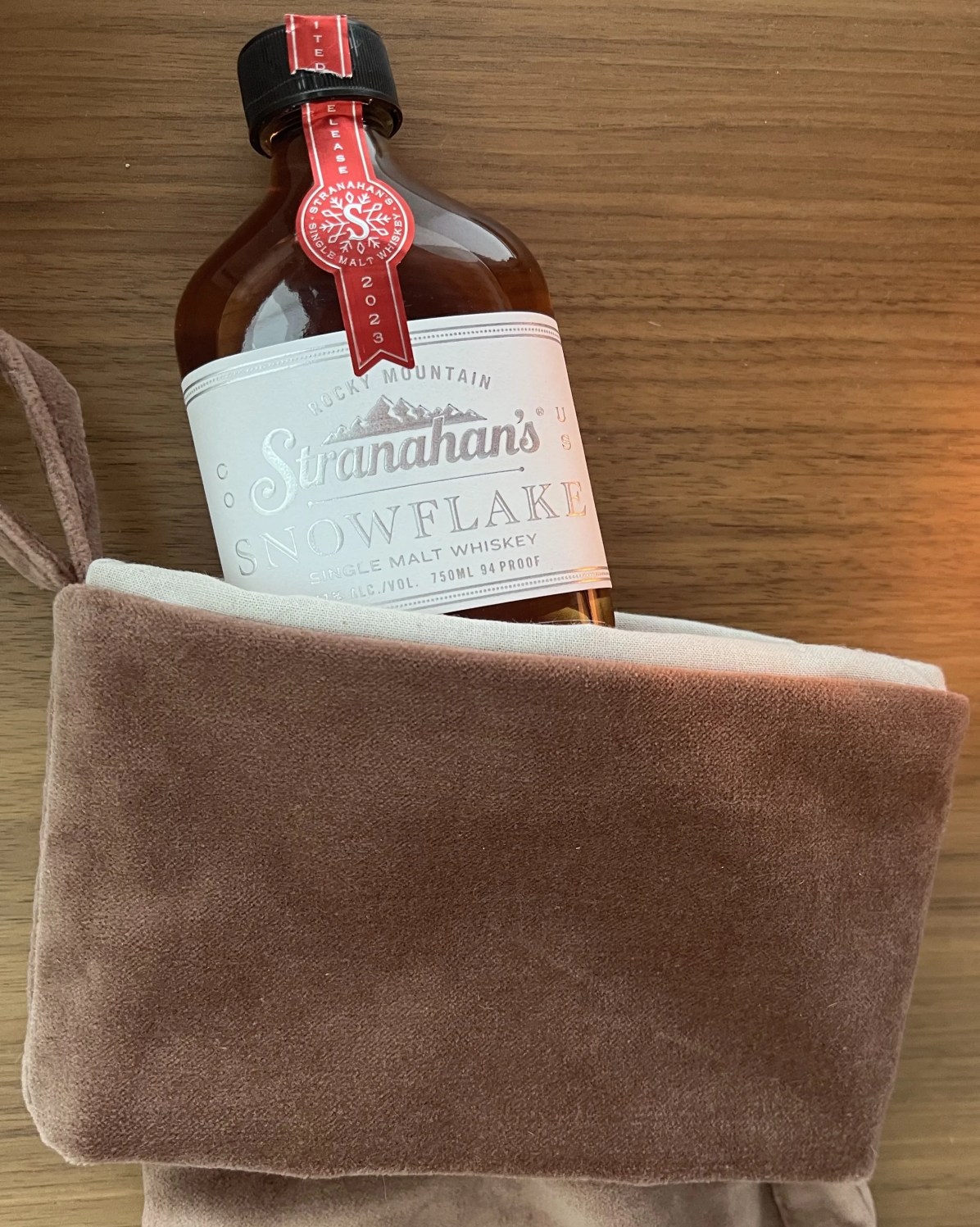 a bottle of liquor on a brown towel