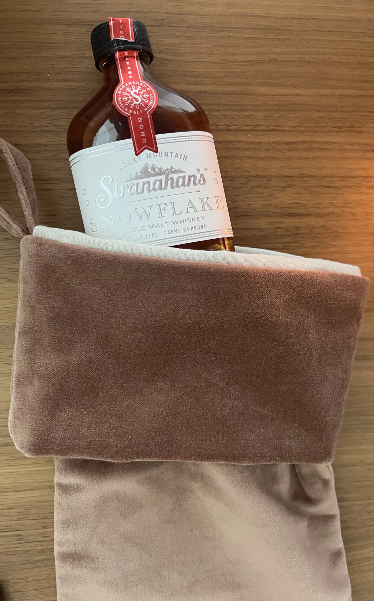 a bottle of liquor on a brown towel